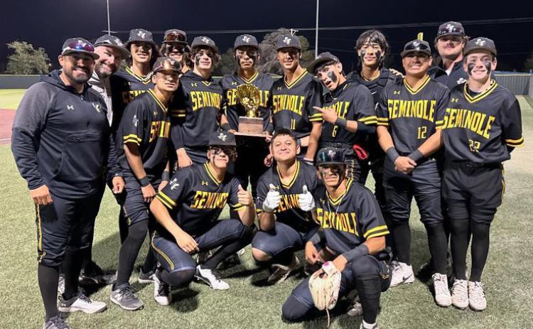 Head coach Chris Gonzales (left) and the Seminole baseball team celebrate after defeating Pecos and winning the District 3-4A title on Friday in Pecos.